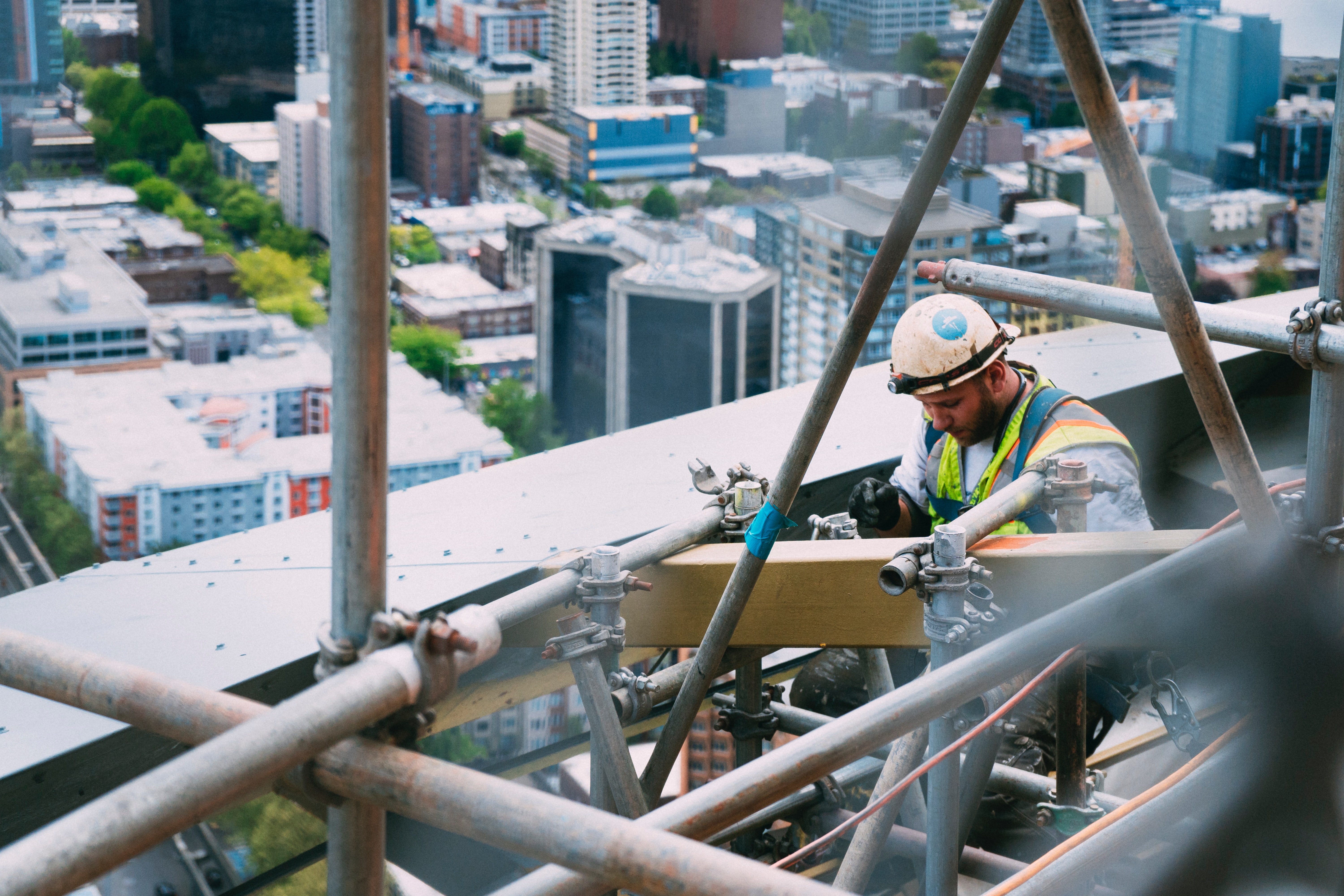 Workman on high rise building scaffolding